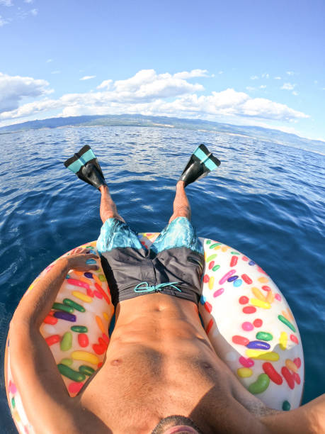 istock Man lying on inflatable ring point of view 1162626648