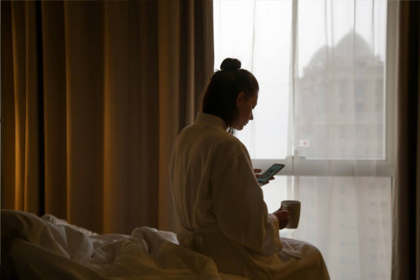 istock Woman drinking the first-morning coffee next to the window 1162628788