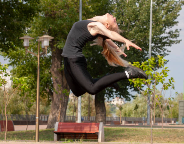 istock Young woman exercising in an urban park 1162631478