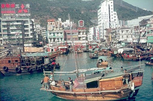 Hong Kong, China, 1971. British Hong Kong from the seafront. Furthermore: boats, locals and buildings.