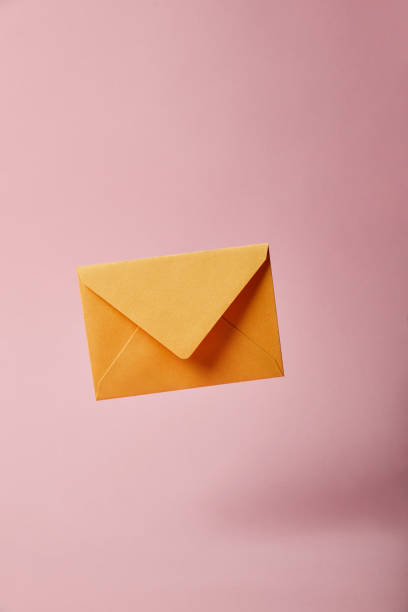 istock yellow and bright envelope on pink background with copy space 1162633228