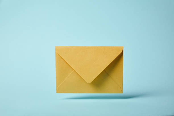 istock yellow and colorful envelope on blue background with copy space 1162633309