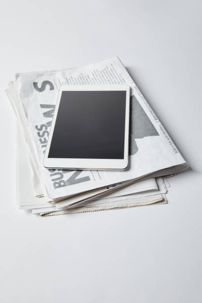 istock digital tablet with blank screen on business newspapers on white 1162635967