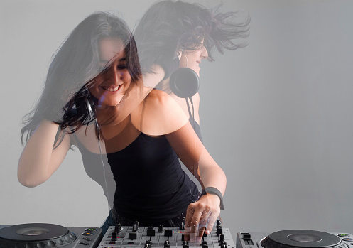 A woman dj in motion, party concepts. Multiple exposure non photoshoped montage.