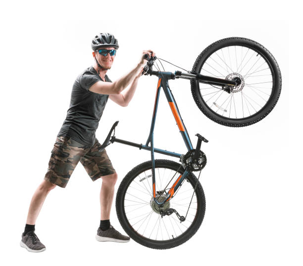 istock young man with mountain bike isolated on white. 1162645736