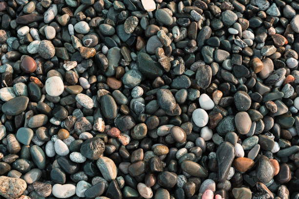 istock sea pebble at the sunset. Background. 1162645784