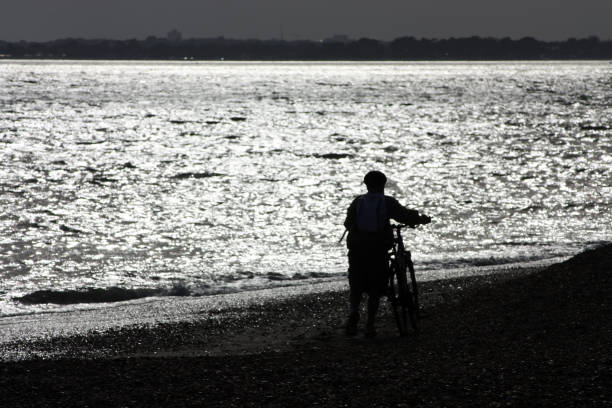 istock Silhouette of cyclist on the beach 1162646724