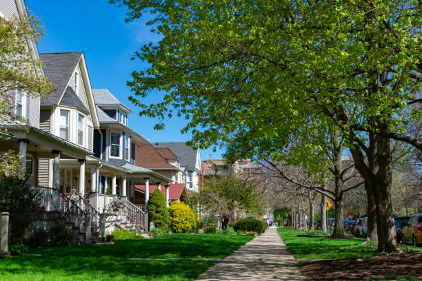 Row of Old Wood Homes with Grass in the North Center Neighborhood of Chicago A row of old wooden homes with front lawns and a sidewalk in the North Center neighborhood of Chicago residential district stock pictures, royalty-free photos & images