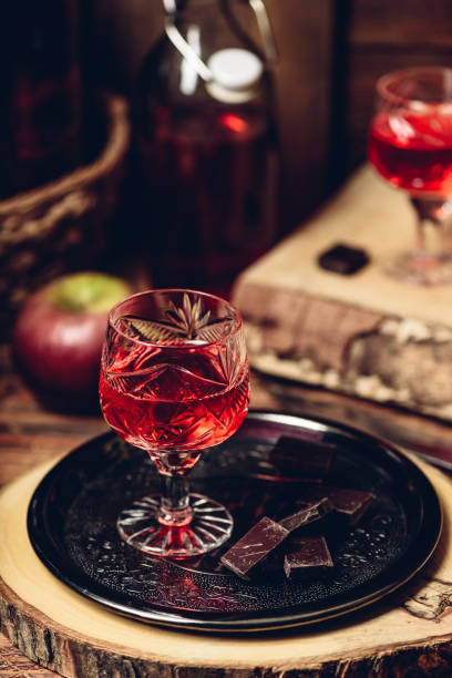 Glass of red liquor with chocolate bars Glass of red liquor with chocolate bars on metal tray nalewka stock pictures, royalty-free photos & images