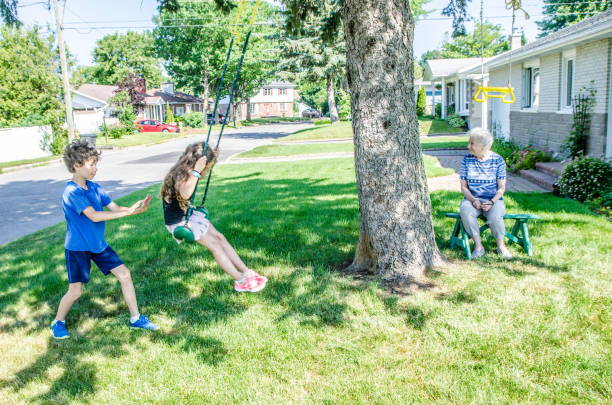 istock Boy pushing sister on swing 1162654423