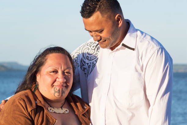 Portrait of an attractive Maori couple taken outdoors stock photo