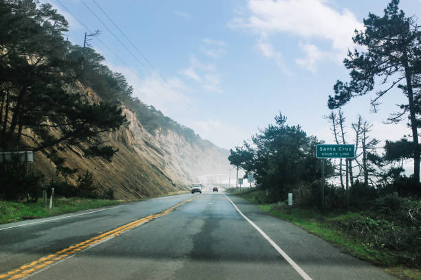 Endless road by the ocean under the cloudy skies near San Francisco, California.