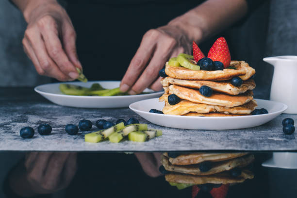 istock Woman preparing pancakes 1162663400