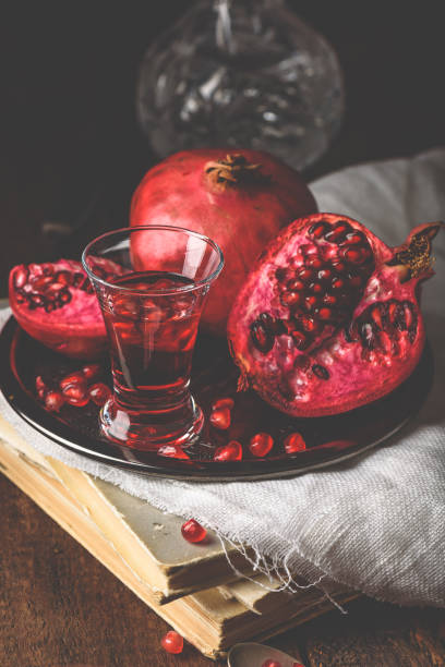 Pomegranate cocktail Pomegranate cocktail with vodka, juice and fresh fruit nalewka stock pictures, royalty-free photos & images