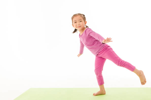istock little girl practice yoga 1162666568