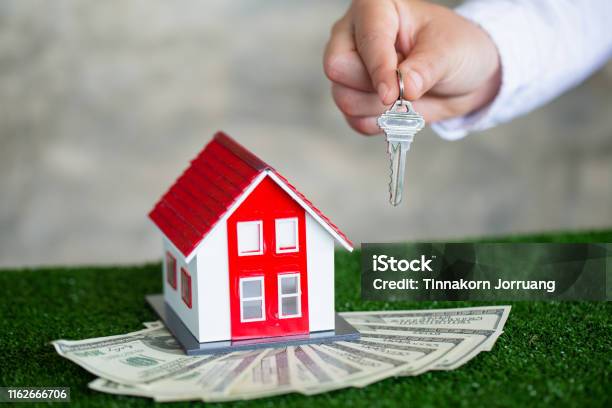Your New House Real Estate Agent Holding House Key To His Client After Signing Contract Agreement In Officeconcept For Real Estate Renting Property Stock Photo - Download Image Now