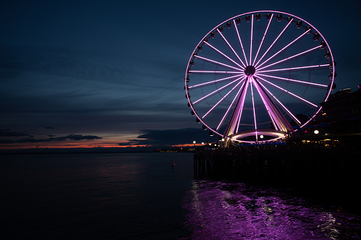 A Ferris Wheel shines at dusk in Seattle.