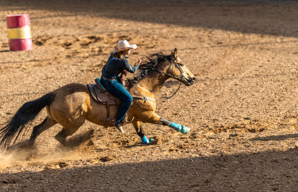 Young cowgirl barrel racing rodeo