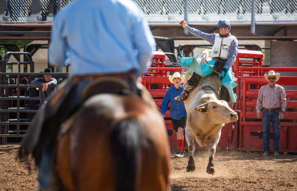 istock Cowboy Bull Riding in Rodeo Arena 1162673798
