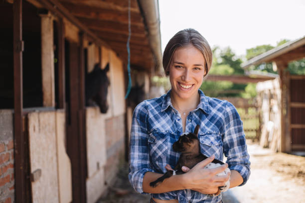 istock Girl holding a small and cute goat 1162676068
