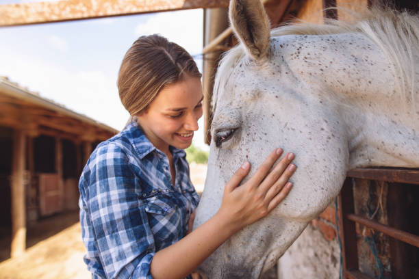 istock Blond girl relaxing with her white stallion 1162676083