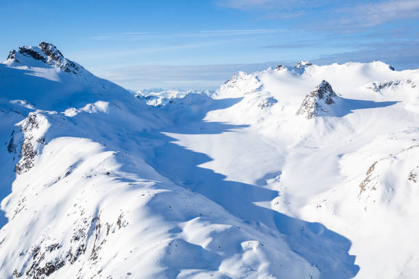 Looking down on the Snowbird Glacier and Nunatak in the distance. Shot from a small peak to the north of the Snowbird Hut. Backcountry skiing looking out over hte Snowbird hut and Snowbird Glacier, surrounding the rocky spire or nunatak in the distance. talkeetna mountains stock pictures, royalty-free photos & images