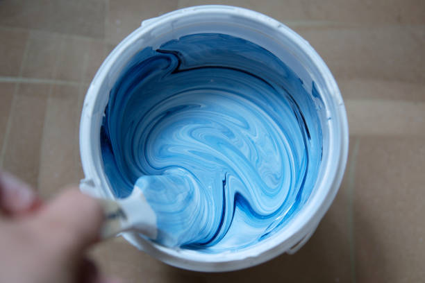 istock Can of white-blue paint (mixing) with a brush 1162680347