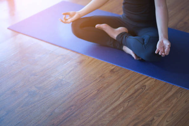 istock Women in meditation while practicing yoga in a training room. Happy, calm and relaxing. 1162680480