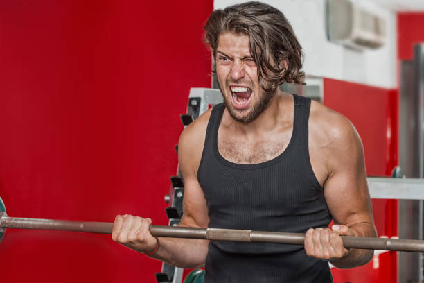 istock Man athlete in the gym 1162683159