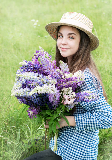 istock Girl in a summer field 1162684811