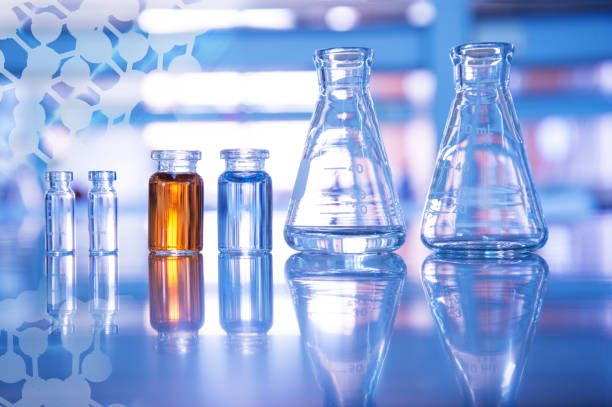 istock glass flask and blue and orange solution in vial for medical science and education experiment laboratory on chemical structure background 1162688792