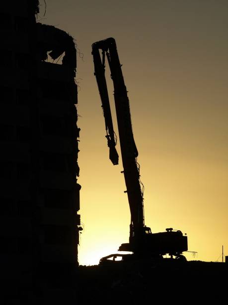 istock Silhouette of excavator at sunset 1162692163
