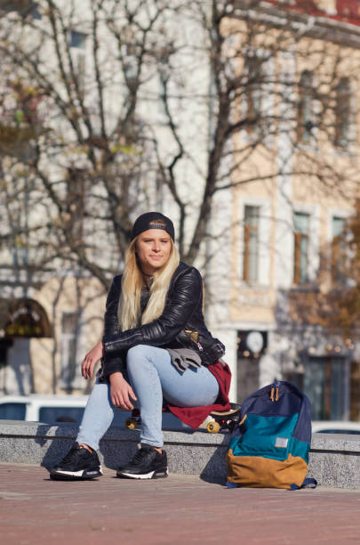 istock Lady girl happy smiles, sits skateboard 1162694652