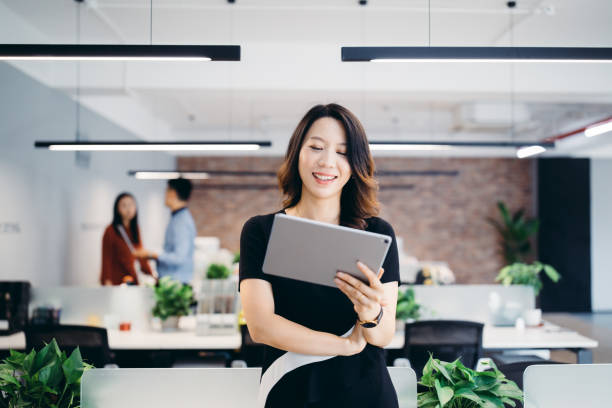 istock Professional Asian businesswoman using digital tablet. 1162699272