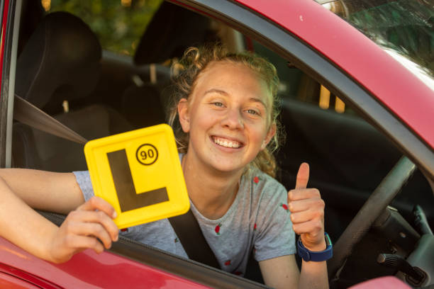 Teenage Girl Celebrating Learning to Drive stock photo