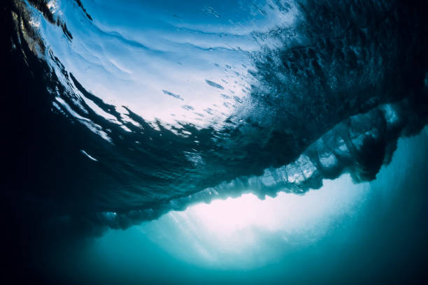 istock Barrel wave underwater with air bubbles and sun light. Ocean in underwater 1162701728