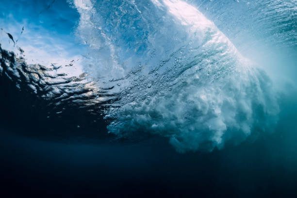istock Barrel wave underwater with air bubbles and sun light. Ocean in underwater 1162701853