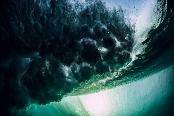 istock Barrel wave underwater with air bubbles and sun light. Ocean in underwater 1162701905