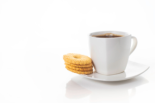 White cups of coffe on light background. Some sweet biscuits