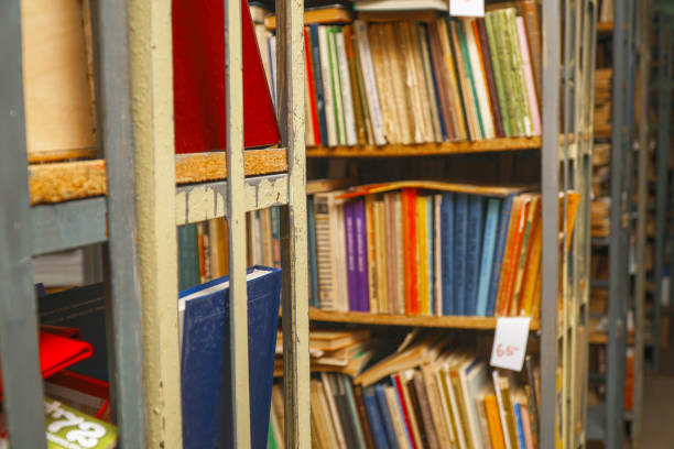 istock Blurred image of old books on bookshelves in library 1162703307