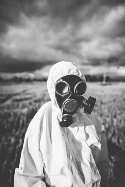 istock Person in protective workwear and gas mask 1162708211