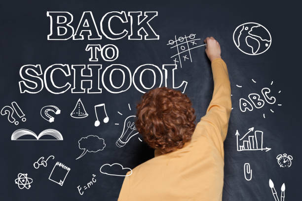 istock Child school boy playing on chalkboard background. Back to school concept 1162709176