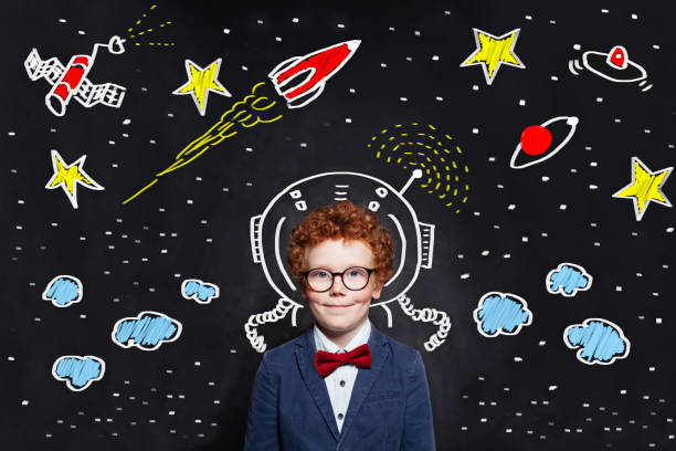 istock Little boy kid astronaut on blackboard background with space scetch 1162709232