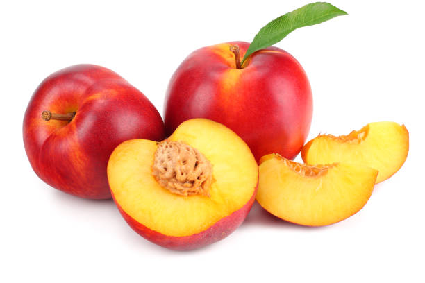 istock Nectarine with green leaf and slices isolated on white background 1162709909