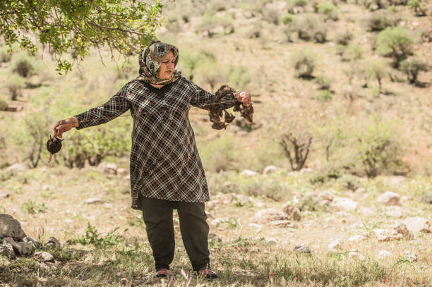 Senior Nomad Woman Spinning Wool for Making Carpet, Iran
