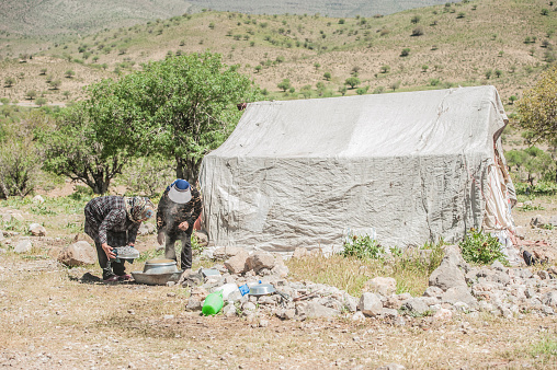 Soldier is standing in the camouflage uniform and checkered keffiyeh shemagh bandana. Terrorist is outdoors in the abandoned deserted place. No war concept and peaceful sign.