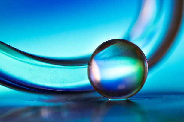 istock Marble on glass plate in blue background 1162711285