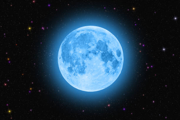 istock Blue super moon glowing against colorful starry sky dark background 1162711397
