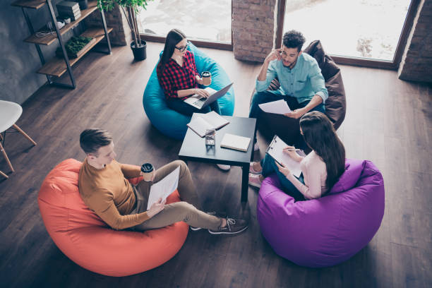 istock Top above high angle view of smart clever interns specialists executive junior managers reviewing financial documentation sitting on bag chair at industrial loft interior workplace workstation 1162711445
