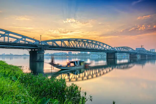 Dawn at Trang Tien Bridge in Hue, Vietnam. This is a Gothic architectural bridge spanning the Perfume river from the 18th century designed by Gustave Eiffel